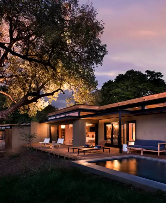 Elegant suite at Lion Sands Ivory Lodge in South Africa, featuring modern architecture, a private pool, and open-air decking.