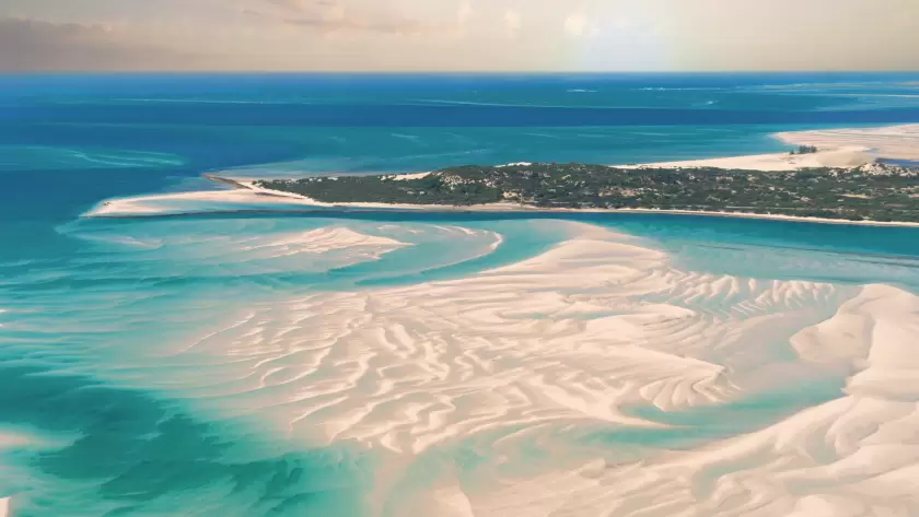 Expansive aerial view of the pristine sandbanks and turquoise waters of the Bazaruto Archipelago in Mozambique.