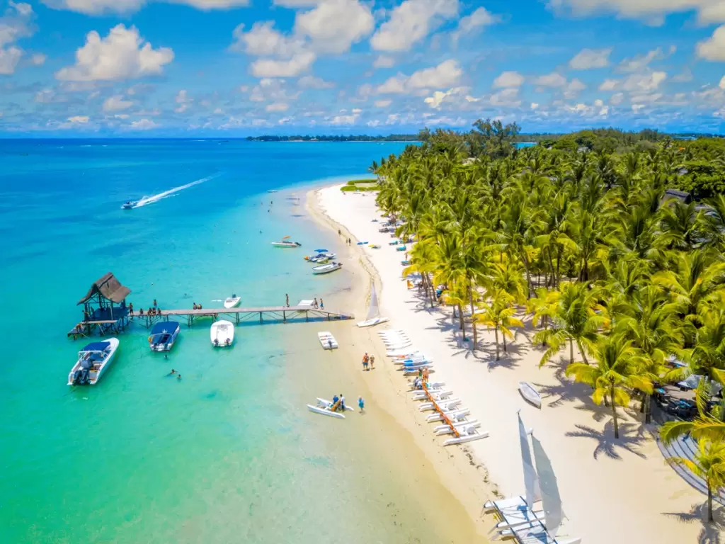 Crystal-clear waters, swaying palm trees, and vibrant marine activities at the stunning Trou aux Biches Beach in Mauritius—paradise found.