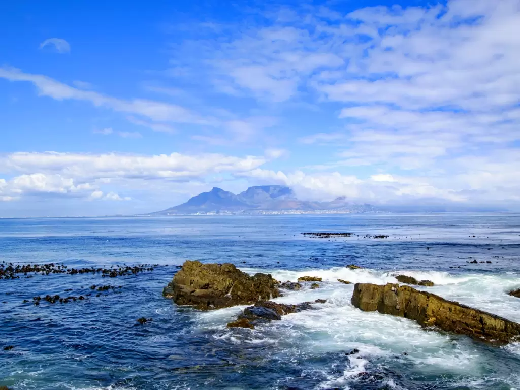 Panoramic ocean view of Robben Island with Table Mountain in the distance, Western Cape, South Africa.