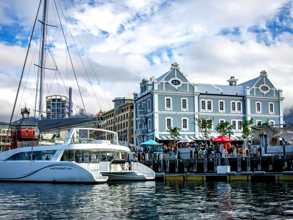 Victoria & Alfred Waterfront with luxury yachts and bustling shopping area, Cape Town attractions.