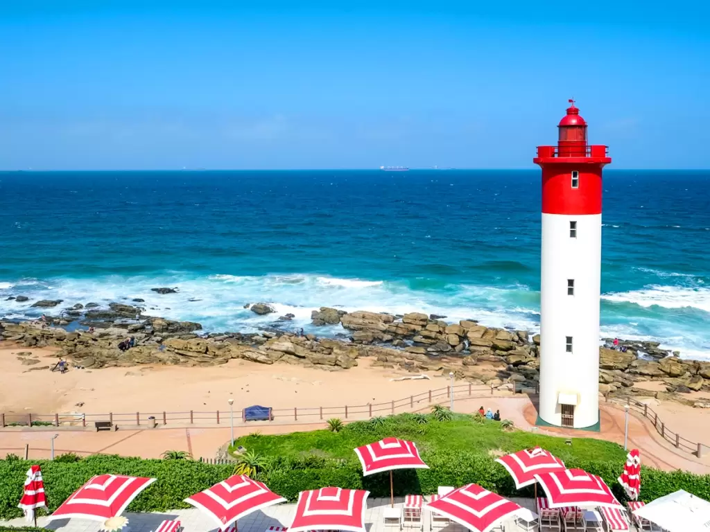 Red and white Umhlanga Lighthouse in a luxury Durban beach holiday in South Africa 2025 / 2026.