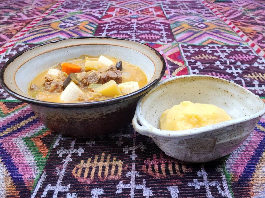Ugali, a traditional Tanzanian dish and a famous African cuisine served with vegetables and meat.
