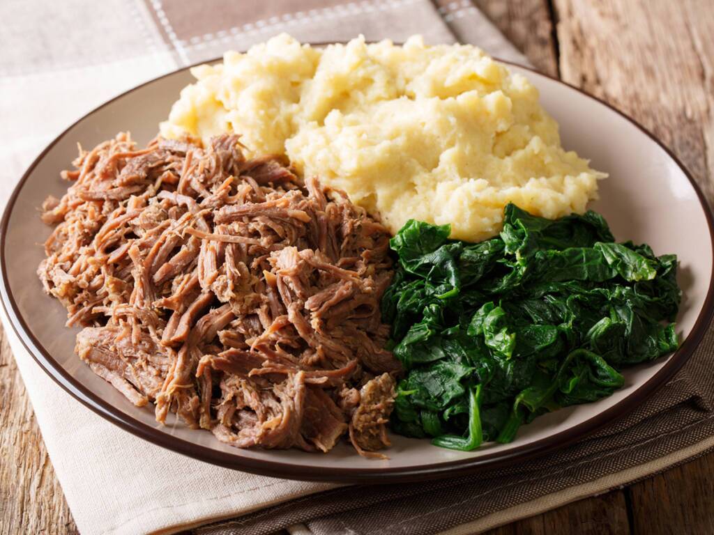 Seswaa – A traditional Botswanan dish of tender shredded meat served with mashed potatoes and greens.