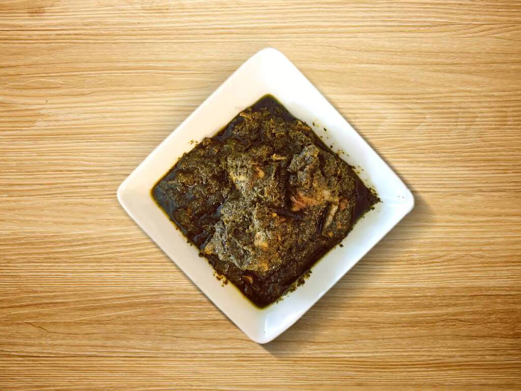 Isombe – A traditional Rwandan dish of cassava leaves cooked in peanut sauce.