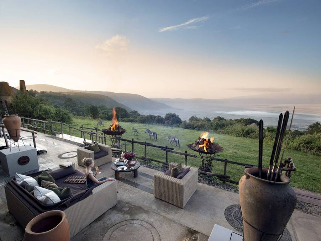 Breathtaking view from a Ngorongoro Crater hotel with zebras grazing in the distance.